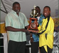 Ebonites receive third place prize trophy from member of Gemonites management team, Tennessee-based Antiguan Vere Henry