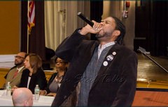 NYC council member Jumaane D. Williams leads the audience in a "No Co-Lo" (No Co-location) chant after his address