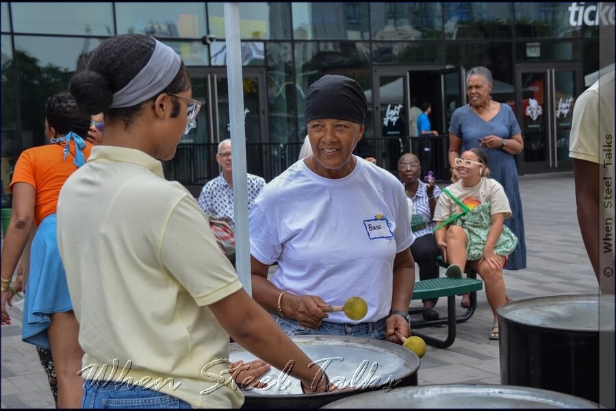 Listening attentively, taking in the guidance for playing the six-bass