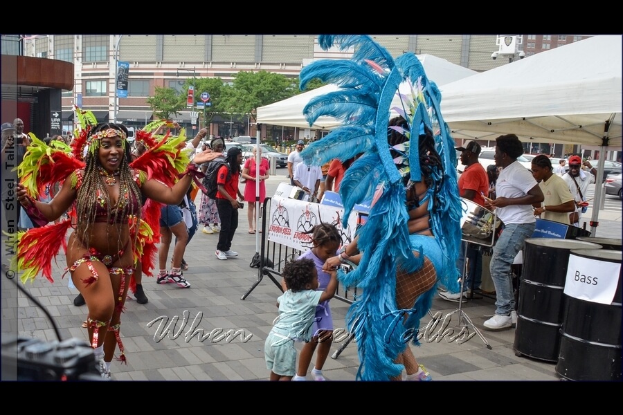 The littlest of fans enjoy dancing with Sesame Flyers’ costumed masqueraders