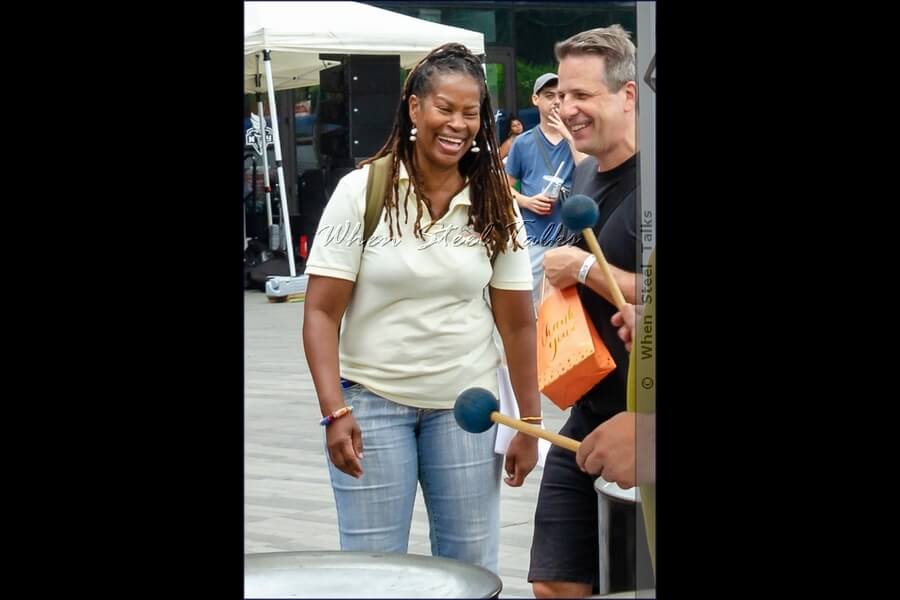 Eruption Steel Orchestra administration Charmine Durrell shares a light-hearted moment with event producer Adam Shore