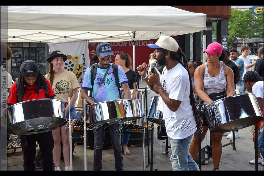 Trying out the steelpan instrument under the guidance of Pan In Motion founder Dr. Kendall K. Williams