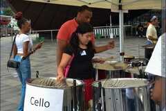 Being introduced to the steelpan instrument, getting a sense of how it is played