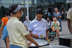 Listening attentively, taking in the guidance for playing the six-bass