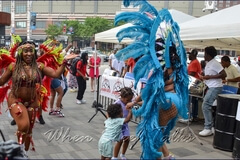 The littlest of fans enjoy dancing with Sesame Flyers’ costumed masqueraders